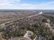 Expansive aerial view of wooded property and homes along a tranquil river setting on a sunny day at 515 Deanne Dr, Rock Hill, SC 29730
