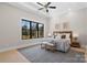 A cozy bedroom with a large window and a tray ceiling with fan at 515 Deanne Dr, Rock Hill, SC 29730