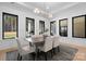 Bright dining room featuring black-trimmed windows, a modern light fixture, and a wood dining table at 515 Deanne Dr, Rock Hill, SC 29730
