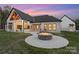 Cozy backyard with a stone fire pit and covered patio, perfect for outdoor relaxation and entertaining at 515 Deanne Dr, Rock Hill, SC 29730