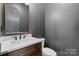 Stylish powder room with modern fixtures, wood vanity, and a large mirror at 515 Deanne Dr, Rock Hill, SC 29730