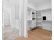 A walk-in closet with built-in shelving leading to a marble tiled bathroom at 515 Deanne Dr, Rock Hill, SC 29730