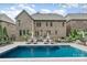 Gorgeous backyard features a sparkling pool, lounge chairs, and well-manicured landscaping at 5430 Open Book Ln, Charlotte, NC 28270