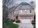 Beautiful two-story home with a brick and stone facade, attached two-car garage, and manicured landscaping at 5430 Open Book Ln, Charlotte, NC 28270