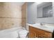 This bathroom features a tub with tile surround, a modern vanity and a mirror at 624 Harris Nw St, Concord, NC 28025