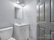 This half-bath has a modern vanity with a mirror and contemporary lighting at 624 Harris Nw St, Concord, NC 28025