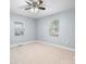 Comfortable bedroom with carpet, two windows, and a ceiling fan at 624 Harris Nw St, Concord, NC 28025