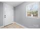 Bright entryway featuring tile flooring, a large window, and a white door at 624 Harris Nw St, Concord, NC 28025