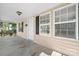 Covered front porch with a decorative railing, black shutters, and a door with the house number at 624 Harris Nw St, Concord, NC 28025