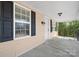 This covered front porch has black shutters, a decorative railing, and house numbers on the door at 624 Harris Nw St, Concord, NC 28025