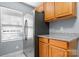 Kitchen featuring stainless steel refrigerator, wooden cabinets, and granite countertops at 624 Harris Nw St, Concord, NC 28025