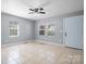 Inviting living room featuring tile flooring and natural light from multiple windows at 624 Harris Nw St, Concord, NC 28025