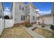 Backyard of a gray two-story home featuring a well kept lawn, patio, string lights, and privacy fence at 786 Stratford Run Dr, Fort Mill, SC 29708