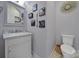 Stylish half bathroom with a marble vanity top, modern fixtures, and decorative wall art at 786 Stratford Run Dr, Fort Mill, SC 29708