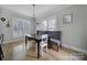 Bright dining area featuring modern light fixture, stylish bench seating, and natural light from nearby windows at 786 Stratford Run Dr, Fort Mill, SC 29708