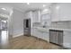 Clean kitchen space showcasing a stainless steel refrigerator, white cabinets, mosaic backsplash, and a farmhouse style sink at 786 Stratford Run Dr, Fort Mill, SC 29708