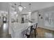 Elegant kitchen island with white countertops, modern pendant lighting, and seating for casual dining at 786 Stratford Run Dr, Fort Mill, SC 29708
