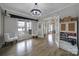 Inviting living room with hardwood floors, large windows, and a seamless connection to other rooms at 786 Stratford Run Dr, Fort Mill, SC 29708