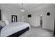 Spacious bedroom featuring a tray ceiling, modern lighting, and ensuite bathroom access at 786 Stratford Run Dr, Fort Mill, SC 29708