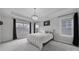 Spacious main bedroom features a tray ceiling, elegant chandelier, large windows, and neutral décor at 786 Stratford Run Dr, Fort Mill, SC 29708