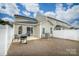 Backyard with an outdoor seating area, grill, and white vinyl fence at 8157 Merryvale Ln, Charlotte, NC 28214