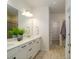Bathroom with double vanity, white cabinets and drawers, and shower with glass doors at 8157 Merryvale Ln, Charlotte, NC 28214