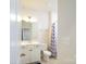 Clean white bathroom with tile flooring and a shower with a curtain at 8157 Merryvale Ln, Charlotte, NC 28214