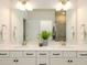 Bathroom with a double vanity, a large mirror and an adjacent shower with glass doors at 8157 Merryvale Ln, Charlotte, NC 28214