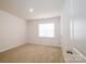 Bright bedroom with neutral walls and carpet flooring, lit by natural light at 8157 Merryvale Ln, Charlotte, NC 28214