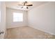 Bedroom features neutral walls, carpet flooring, and a ceiling fan with a light at 8157 Merryvale Ln, Charlotte, NC 28214
