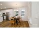 Bright dining area with modern light fixture, hardwood floors, and large windows, creating a welcoming atmosphere at 8157 Merryvale Ln, Charlotte, NC 28214