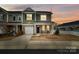 Charming two-story townhouse showcasing stone accents, a one-car garage and a welcoming front porch at 8157 Merryvale Ln, Charlotte, NC 28214