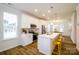 Bright kitchen features white cabinets, stainless steel appliances, and a breakfast bar with seating at 8157 Merryvale Ln, Charlotte, NC 28214