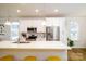 Well-lit kitchen featuring stainless steel appliances, granite countertops, an island with seating and hardwood floors at 8157 Merryvale Ln, Charlotte, NC 28214