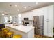 Modern kitchen with stainless steel appliances, a kitchen island with seating, and a connecting living room at 8157 Merryvale Ln, Charlotte, NC 28214