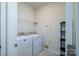 Functional laundry room with white appliances, a shelf, and ample space for organization at 8157 Merryvale Ln, Charlotte, NC 28214