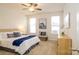 Cozy main bedroom features soft carpet, a ceiling fan, and ample natural light from two windows at 8157 Merryvale Ln, Charlotte, NC 28214