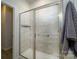 Bathroom shower with glass doors and tiled walls, offering a clean and modern look at 8157 Merryvale Ln, Charlotte, NC 28214