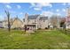 Expansive backyard with a pergola covered patio, and mature trees, perfect for outdoor entertaining and relaxation at 8932 Raven Park Dr, Charlotte, NC 28216