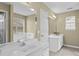 Light and bright bathroom with double vanity, two mirrors, and natural light at 8932 Raven Park Dr, Charlotte, NC 28216