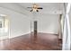 Primary bedroom with wood floors, neutral walls, two large windows, and ensuite bathroom at 8932 Raven Park Dr, Charlotte, NC 28216