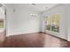 Bright dining room with hardwood floors, neutral paint, and a modern chandelier at 8932 Raven Park Dr, Charlotte, NC 28216