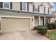 Charming two-story home with attached garage, manicured shrubs, and a welcoming front porch at 8932 Raven Park Dr, Charlotte, NC 28216