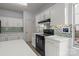Well-lit kitchen with white cabinets, tiled backsplash, and modern appliances providing an inviting space for cooking and entertaining at 8932 Raven Park Dr, Charlotte, NC 28216
