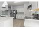 Modern kitchen with stainless steel appliances, white cabinetry, and a decorative tile backsplash at 8932 Raven Park Dr, Charlotte, NC 28216