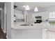 Well-lit kitchen with modern appliances, white cabinetry, and a decorative backsplash at 8932 Raven Park Dr, Charlotte, NC 28216