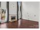 Spacious living room with a fireplace, high ceilings, large windows, and hardwood floors at 8932 Raven Park Dr, Charlotte, NC 28216