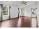 Spacious living room with wood-look floors, large windows and vaulted ceiling creating a bright and welcoming area for relaxation at 8932 Raven Park Dr, Charlotte, NC 28216