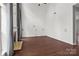 Bright living room featuring hardwood floors and a fireplace with large windows and neutral paint at 8932 Raven Park Dr, Charlotte, NC 28216