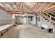 Unfinished basement features concrete block walls, mechanicals, and stairs leading to the upper level at 920 Oakridge Farm Hwy, Mooresville, NC 28115